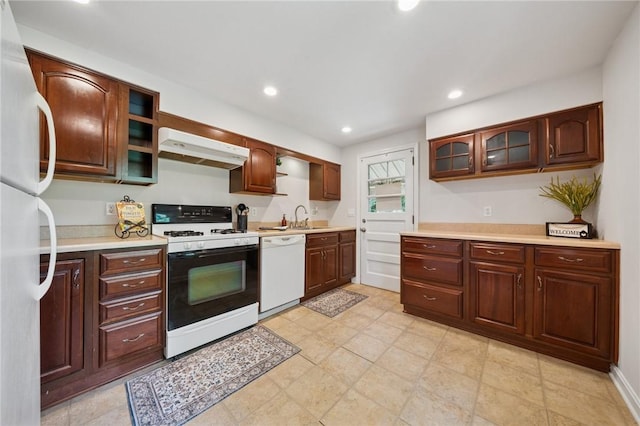 203 Clever Ave, Mckees Rocks, PA 15136 - kitchen with white appliances, exhaust hood, light countertops, glass insert cabinets, and recessed lighting