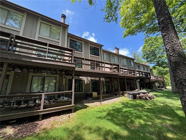 13 Lakeview Dr, Hidden Valley, PA 15502 - back of property with board and batten siding, a lawn, and a deck