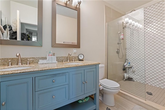 160 45th St, Lawrenceville, PA 15201 - full bathroom featuring a shower stall, double vanity, and wood finished floors