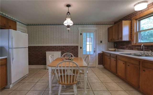 267 Blackhawk Rd, Chippewa Twp, PA 15010 - kitchen with freestanding refrigerator, wallpapered walls, light tile patterned floors, brown cabinets, and healthy amount of natural light