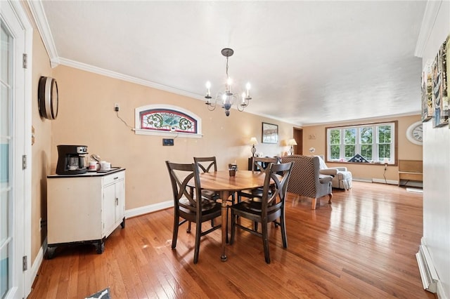 128 Honey Suckle Ln, Unity Twp, PA 15601 - dining space featuring light wood-type flooring, ornamental molding, and a chandelier