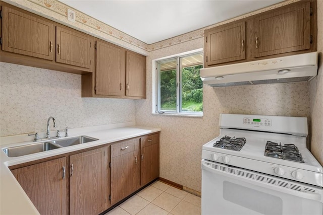 809 Sleepy Hollow Rd, Castle Shannon, PA 15234 - kitchen featuring gas range gas stove, under cabinet range hood, wallpapered walls, light countertops, and light tile patterned flooring
