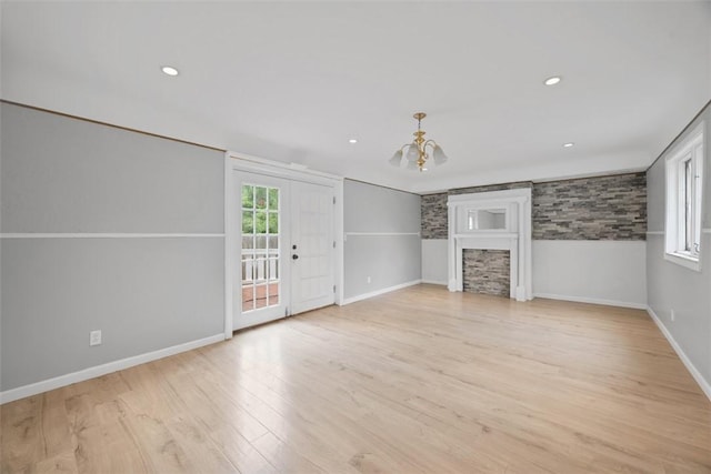 146 Mill St, Penn Hills, PA 15147 - unfurnished living room with a chandelier, light wood-style flooring, a fireplace, and recessed lighting