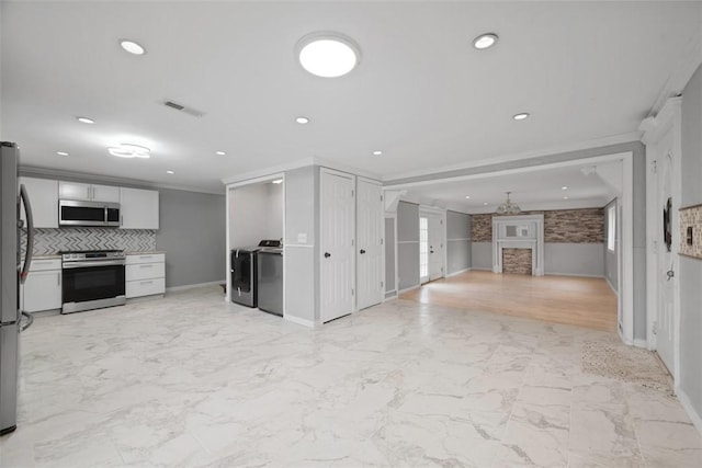 146 Mill St, Penn Hills, PA 15147 - unfurnished living room featuring wainscoting, light marble finish flooring, washer and dryer, recessed lighting, and ornamental molding