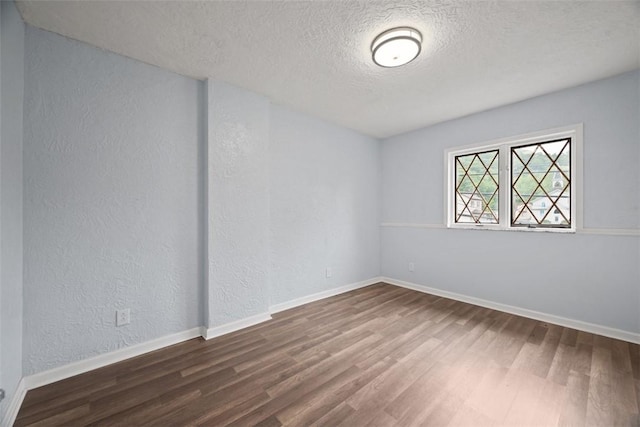 146 Mill St, Penn Hills, PA 15147 - unfurnished room with wood finished floors, a textured ceiling, and a textured wall