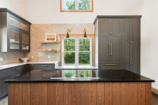 50 Hawes Rd, Wharton Twp, PA 15437 - kitchen featuring stovetop, decorative backsplash, dark stone countertops, open shelves, and gray cabinets