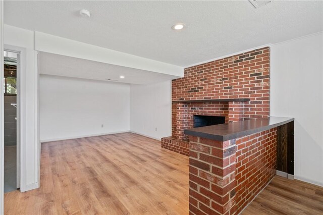 404 Beulah St, Shaler, PA 15209 - unfurnished living room with wood finished floors, a fireplace, and recessed lighting