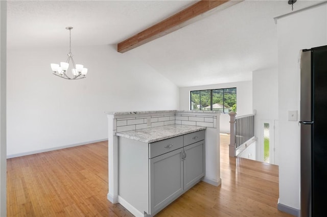 404 Beulah St, Shaler, PA 15209 - kitchen with freestanding refrigerator, gray cabinetry, light wood-type flooring, a chandelier, and pendant lighting