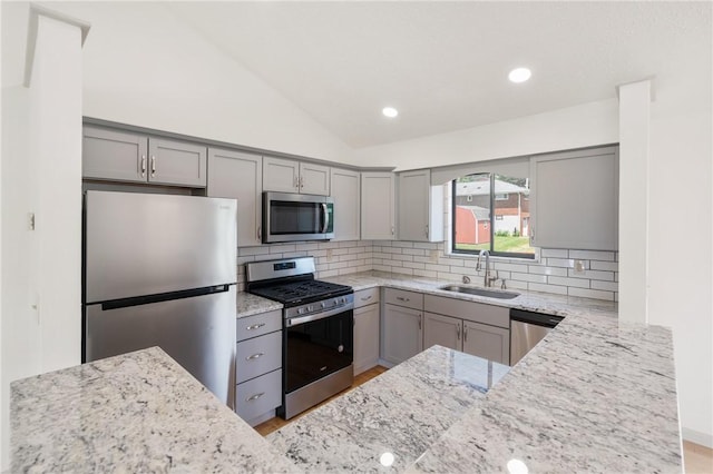 404 Beulah St, Shaler, PA 15209 - kitchen featuring appliances with stainless steel finishes, gray cabinetry, light stone counters, lofted ceiling, and recessed lighting