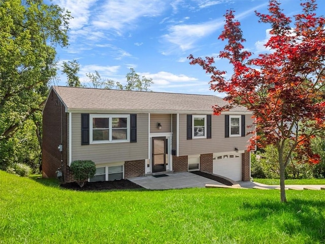773 Somerville Dr, Saint Clair, PA 15243 - split foyer home featuring a garage, a front lawn, and brick siding