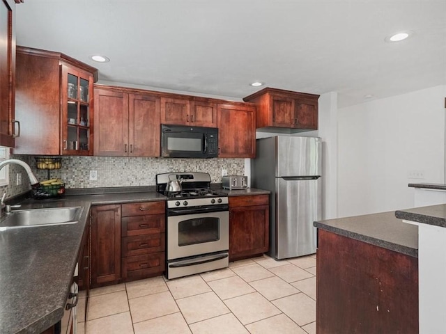 773 Somerville Dr, Saint Clair, PA 15243 - kitchen featuring appliances with stainless steel finishes, dark countertops, decorative backsplash, light tile patterned floors, and recessed lighting