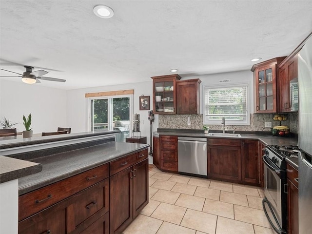773 Somerville Dr, Saint Clair, PA 15243 - kitchen featuring appliances with stainless steel finishes, dark countertops, tasteful backsplash, glass insert cabinets, and recessed lighting