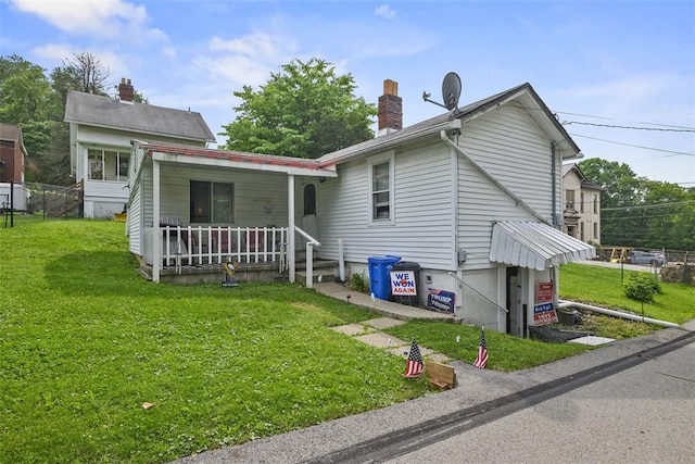 11839 Crockett St, North Huntingdon, PA 15647 - rear view of house featuring a porch, a chimney, and a yard