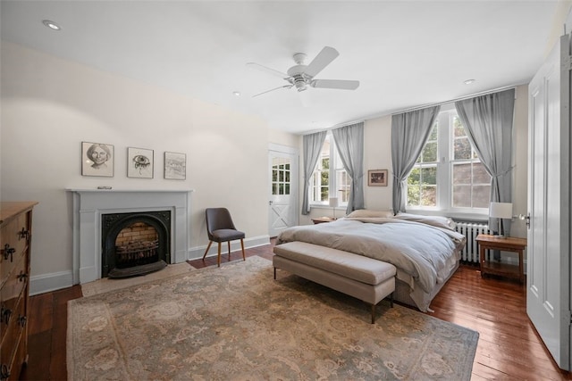 904-906 Blackburn Rd, Sewickley Heights, PA 15143 - bedroom featuring radiator heating unit, wood-type flooring, a ceiling fan, and a fireplace with flush hearth