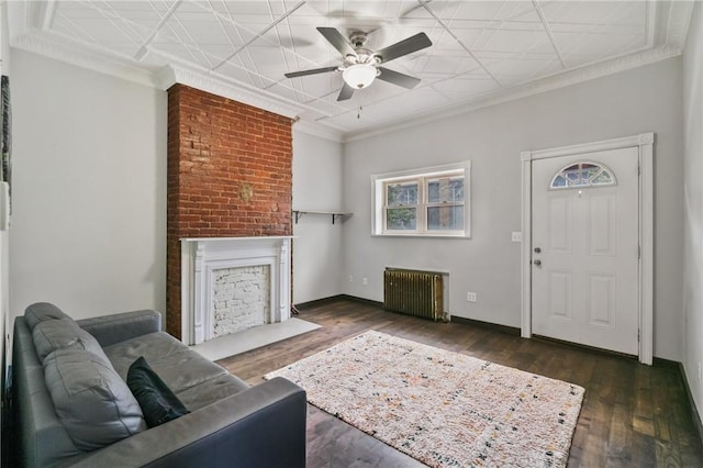 4034 Willow St, Lawrenceville, PA 15201 - living area with radiator, a large fireplace, ceiling fan, wood finished floors, and ornamental molding