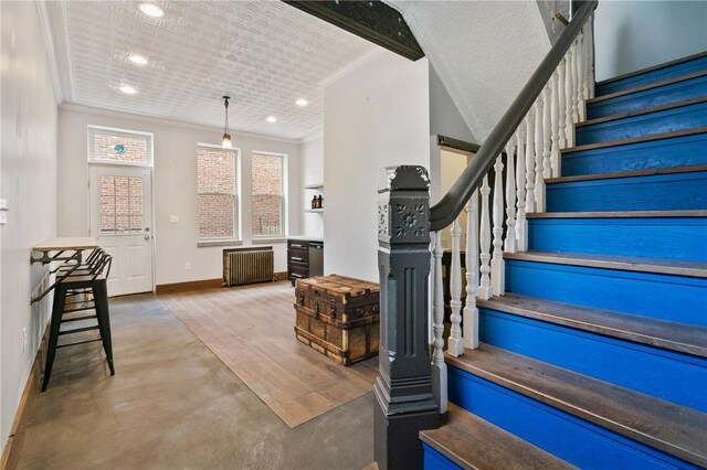 4034 Willow St, Lawrenceville, PA 15201 - stairway with radiator heating unit, crown molding, and recessed lighting