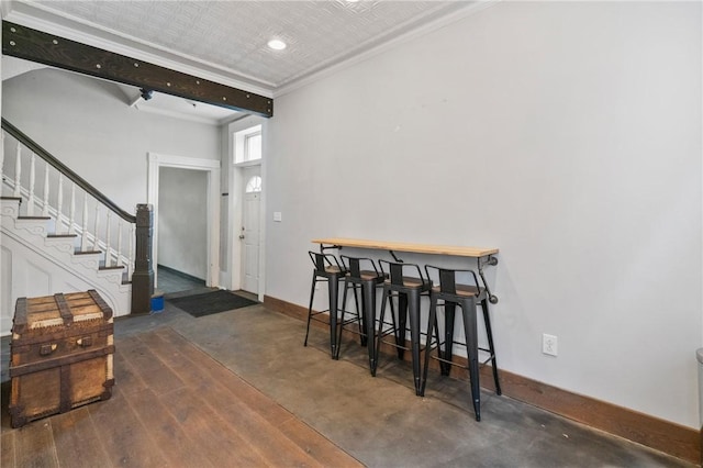 4034 Willow St, Lawrenceville, PA 15201 - dining space with stairway, a bar, crown molding, and recessed lighting