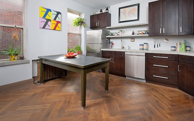 4034 Willow St, Lawrenceville, PA 15201 - kitchen with appliances with stainless steel finishes, open shelves, dark brown cabinetry, radiator heating unit, and light countertops