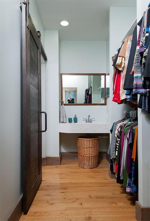 4034 Willow St, Lawrenceville, PA 15201 - spacious closet featuring a barn door and wood finished floors