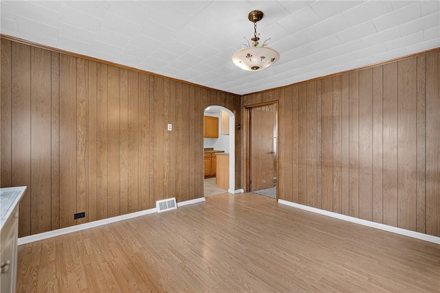 41 Taylor Ave, East Bethlehem, PA 15322 - unfurnished room featuring arched walkways, light wood-style flooring, and wooden walls