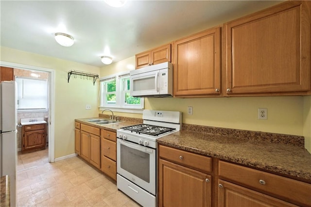 41 Taylor Ave, East Bethlehem, PA 15322 - kitchen featuring white appliances, dark countertops, and brown cabinets