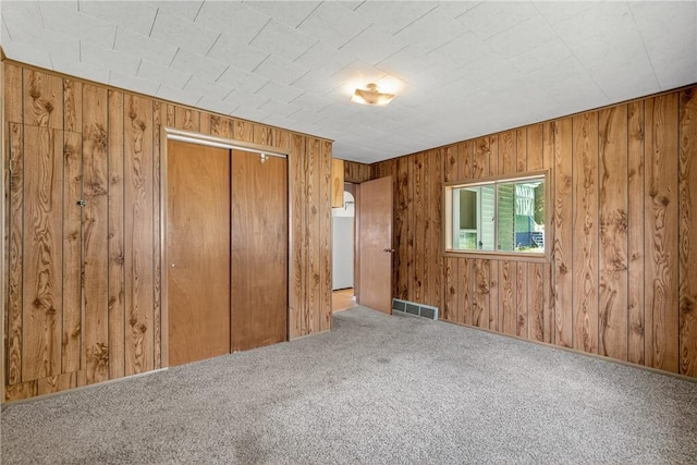 41 Taylor Ave, East Bethlehem, PA 15322 - unfurnished bedroom with carpet, wooden walls, and a closet