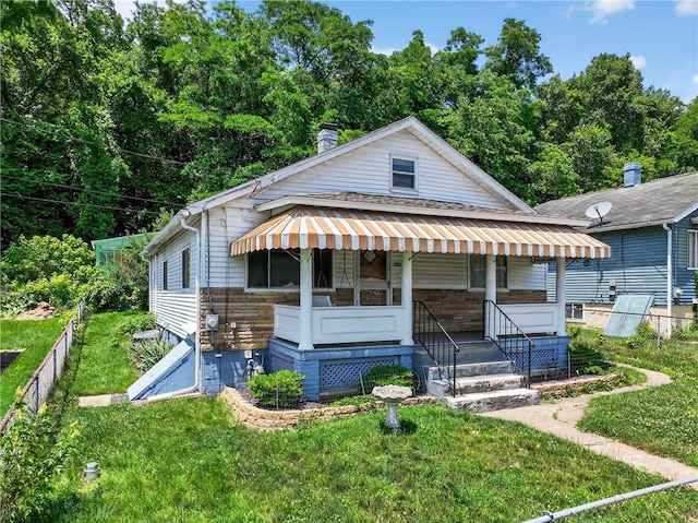 41 Taylor Ave, East Bethlehem, PA 15322 - view of front of home featuring a front yard, a chimney, and covered porch