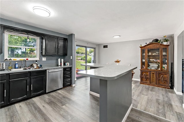 553 Indus St, Greenfield, PA 15207 - kitchen with dishwasher, light countertops, dark cabinets, and light wood-type flooring