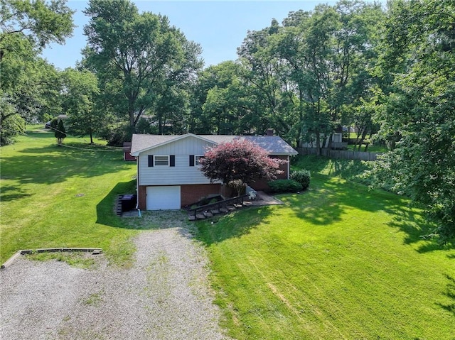 325 Clements Rd, Plum Boro, PA 15239 - view of home's exterior with a garage, driveway, a yard, brick siding, and view of wooded area