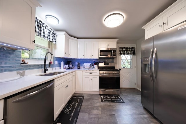 325 Clements Rd, Plum Boro, PA 15239 - kitchen with appliances with stainless steel finishes, decorative backsplash, white cabinetry, and light countertops