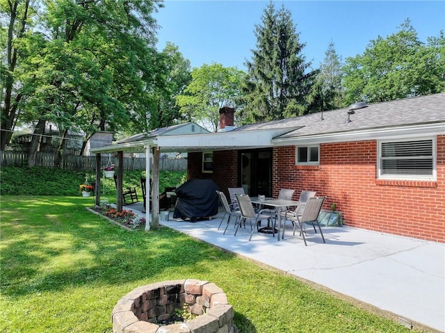 325 Clements Rd, Plum Boro, PA 15239 - back of property featuring a fire pit, brick siding, a patio, a chimney, and roof with shingles