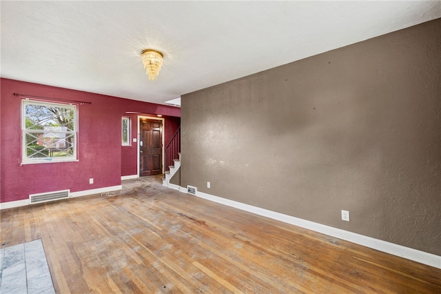 1000 Prospect Rd, Whitehall, PA 15227 - unfurnished room with wood finished floors, stairway, and a textured wall