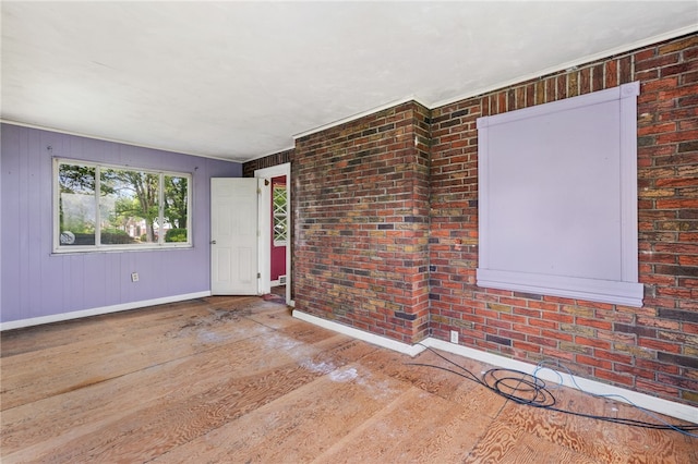 1000 Prospect Rd, Whitehall, PA 15227 - unfurnished room featuring wood finished floors and brick wall