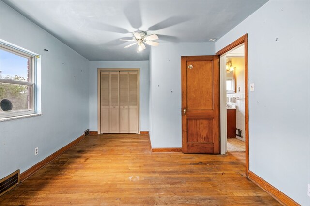 1000 Prospect Rd, Whitehall, PA 15227 - unfurnished bedroom with a closet, wood finished floors, and a ceiling fan