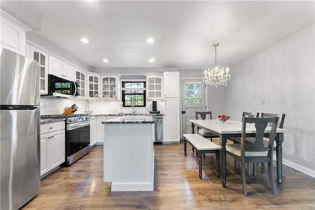 202 Lytton Rd, Moon/Crescent Twp, PA 15108 - kitchen featuring stainless steel appliances, a chandelier, a kitchen island, white cabinets, and glass insert cabinets