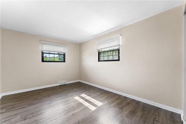 202 Lytton Rd, Moon/Crescent Twp, PA 15108 - empty room with healthy amount of natural light and dark wood-style flooring