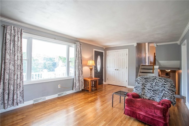 101 Lynne Dr, Big Beaver, PA 15010 - living area featuring ornamental molding, healthy amount of natural light, wood finished floors, and stairs