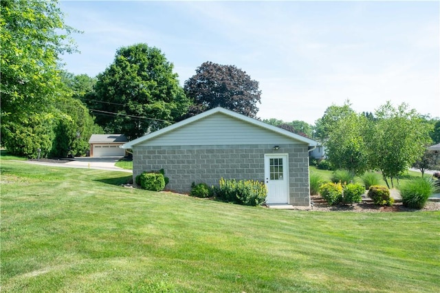 101 Lynne Dr, Big Beaver, PA 15010 - view of side of property featuring a lawn, concrete block siding, and an outdoor structure