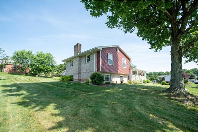 101 Lynne Dr, Big Beaver, PA 15010 - view of side of property featuring a chimney, a yard, and brick siding