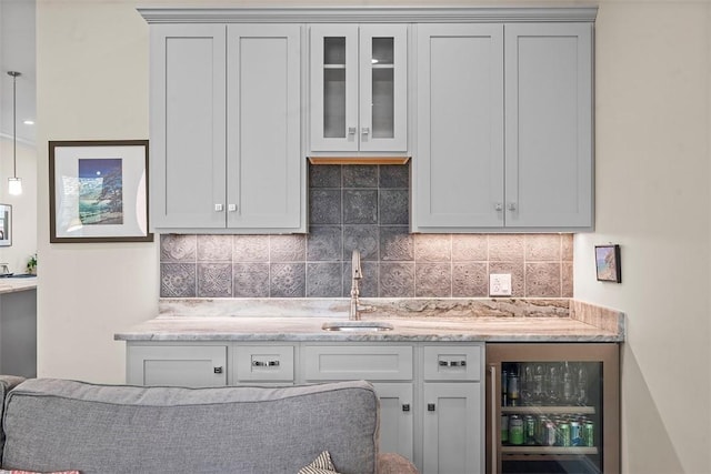 246 42nd St, Lawrenceville, PA 15201 - kitchen featuring light stone countertops, beverage cooler, tasteful backsplash, and glass insert cabinets