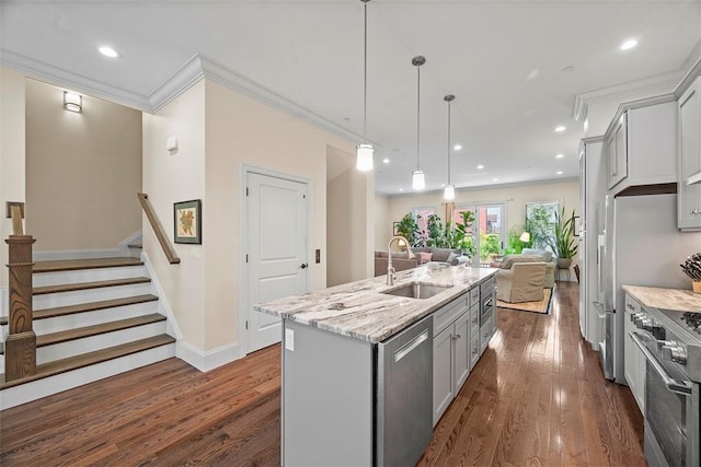 246 42nd St, Lawrenceville, PA 15201 - kitchen featuring stainless steel appliances, gray cabinets, open floor plan, dark wood-style flooring, and an island with sink