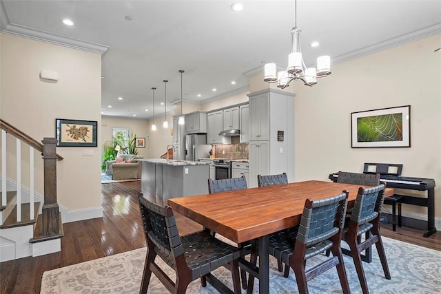 246 42nd St, Lawrenceville, PA 15201 - dining area with crown molding, stairway, a chandelier, dark wood-style flooring, and recessed lighting