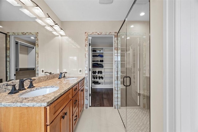 246 42nd St, Lawrenceville, PA 15201 - bathroom featuring a spacious closet, a shower stall, double vanity, and tile patterned floors