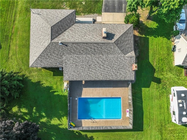 view of subject property with a pool