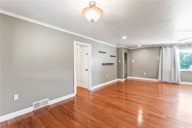 empty room with ornamental molding, wood finished floors, and recessed lighting