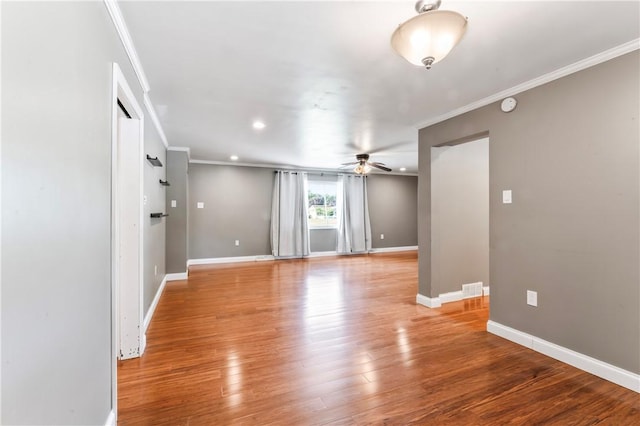 spare room featuring ceiling fan, ornamental molding, light wood-style flooring, a smoke detector, and recessed lighting
