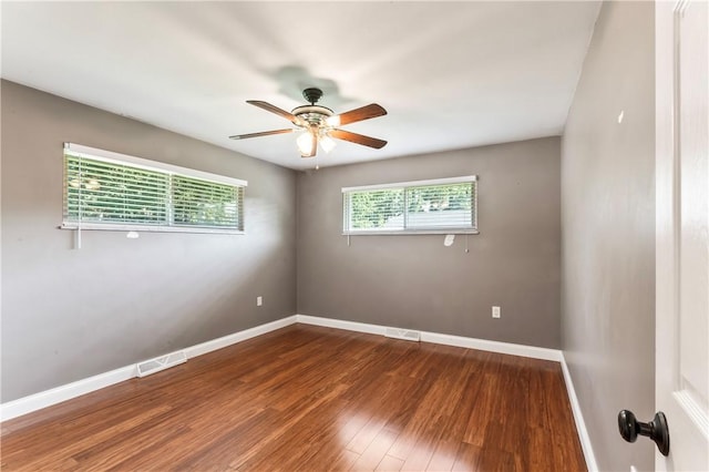 spare room with ceiling fan and wood finished floors