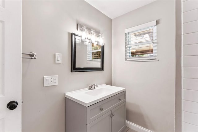 bathroom with vanity and baseboards