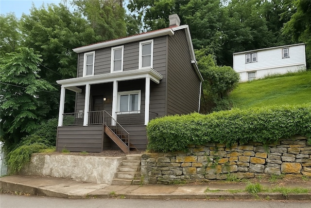 7 Prospect St, Etna, PA 15223 - view of front of home with stairs, a chimney, stone siding, and covered porch