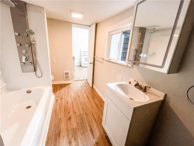 7 Prospect St, Etna, PA 15223 - full bathroom featuring vanity, wood finished floors, and washer / dryer